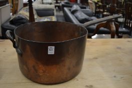 A large copper saucepan.