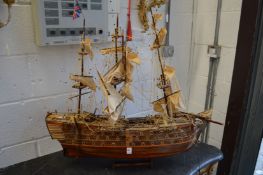 A large wooden model of a gun ship.