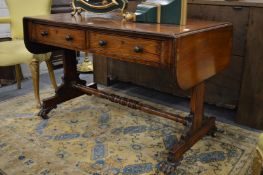 A Regency rosewood sofa table with two frieze drawers, two dummy drawers on column supports with