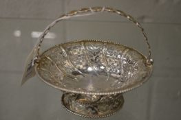 A silver sugar basket with pierced decoration.