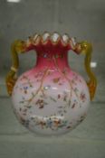 A good opaque glass frilly edged twin handled vase with enamel decoration.