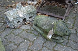 Garden ornament modelled as a pig together with another item.