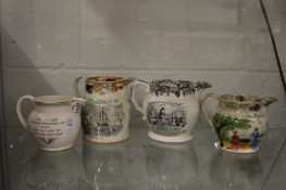 Four various Staffordshire commemorative jugs.