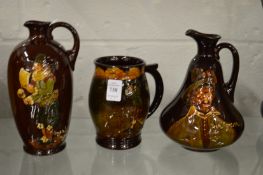 Two Doulton Dewars whisky jugs together with a similar golfing jug.