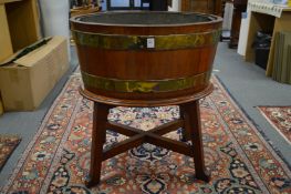 A teak and brass bound oval jardiniere on stand.
