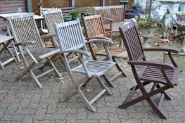 Two pairs of hardwood folding garden armchairs and a similar chair.