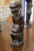 An unusual African carved hardwood figure group.