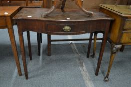 A 19th century mahogany serpentine fronted single drawer side table.