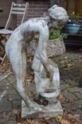 A garden ornament modelled as a classical female nude standing by a well.