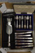 A cased set of butter knives, a set of teaspoons and a cake slice.