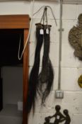 Two animal tail fly whisks.