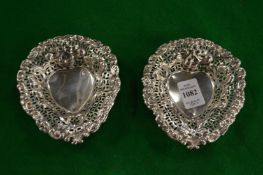 A pair of pierced silver heart shaped bonbon dishes.