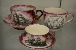 A Sunderland lustre ware large cup and saucer, similar cup and a smaller cup and saucer.