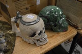 An unusual skull shaped tankard and a carved hard stone model of a skull.