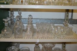 A pair of cut glass decanters, various other decanters and drinking glasses.