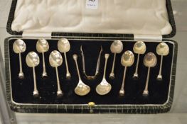 A cased set of twelve silver coffee spoons and sugar tongs.