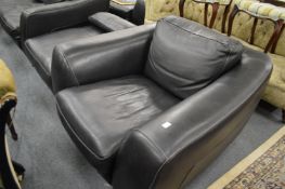 A good Iarge Italian black leather armchair and footstool by Incanto.
