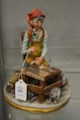 A Capodimonte figure of a young cobbler.