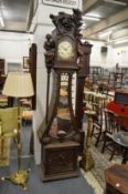 An unusual large Continental carved walnut longcase clock.