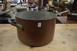 A very large copper saucepan.