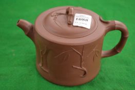 A Chinese Yixing teapot.