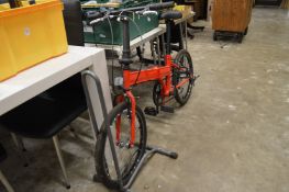 A folding bike with stand.