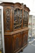 A large 19th century continental walnut two-part cabinet, the upper section with pair of glazed