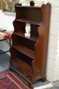 A mahogany waterfall style bookcase.