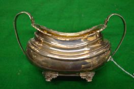 A silver twin handled sugar bowl.