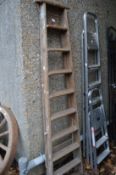 A wooden step ladder and two aluminium step ladders.