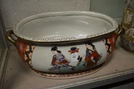 A large pottery foot bath decorated in a Chinese style.