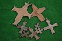 A group of bronze crucifixes.