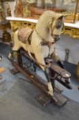 A good early large cream painted rocking horse.