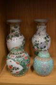 A pair of Chinese baluster shaped vases and two ginger jars and covers.