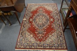 A Persian style rug, red ground with floral decoration 190cm x 120cm.