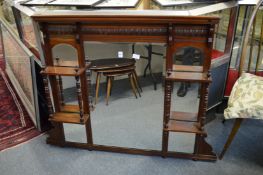A Victorian walnut oval mantel mirror with shelves.