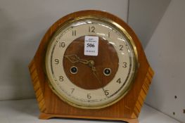 A walnut mantel clock.