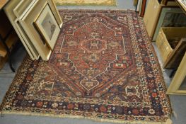 A Persian Shiraz carpet with stylised decoration 200cm x 170cm.