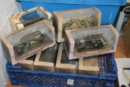 A quantity of die-cast military vehicles, boxed, unopened.