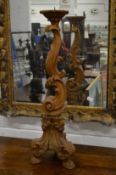 A carved wood pricket candle stand.