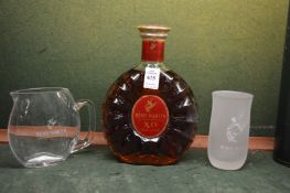 Remy Martin XO cognac with branded glass jug and six frosted glasses.