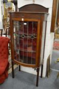 An Edwardian mahogany bow front display cabinet.