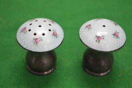 A pair of silver and enamel decorated mushroom shape salt and peppers.