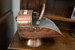 A copper coal scuttle.