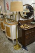 A brass floor standing adjustable lamp and pair of similar wall lights.