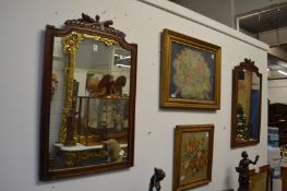 A pair of walnut framed mirrors with carved crestings.