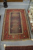 A small Belouch rug (worn) 150cm x 100cm.