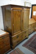 A George III mahogany linen press with pair of panel doors enclosing five sliding shelves, the