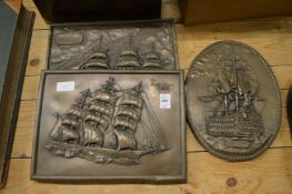 Three bronzed pottery plaques depicting sailing ships.