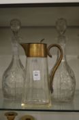 A claret jug and pair of decanters.